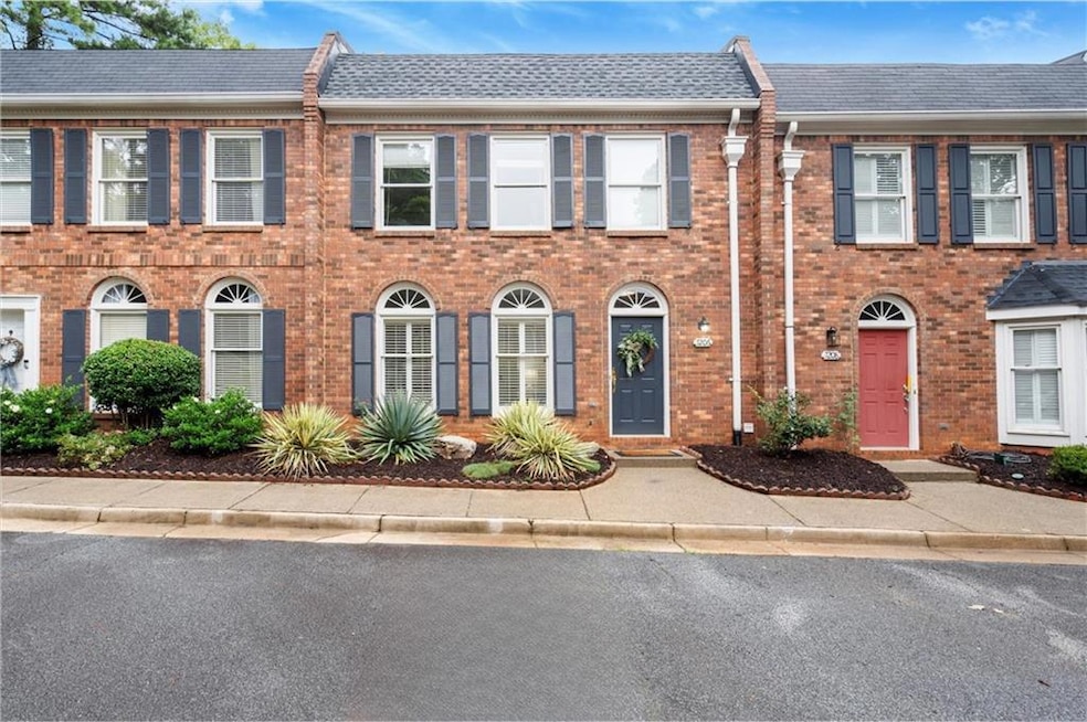 View of front of property with brick siding and a shingled roof