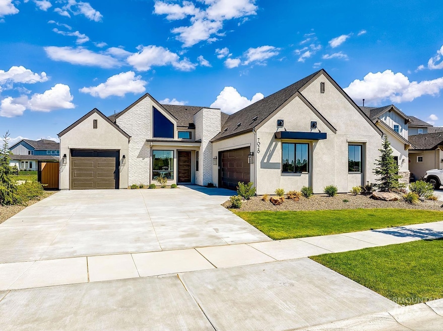 Modern farmhouse style home with an attached garage, concrete driveway, and stucco siding