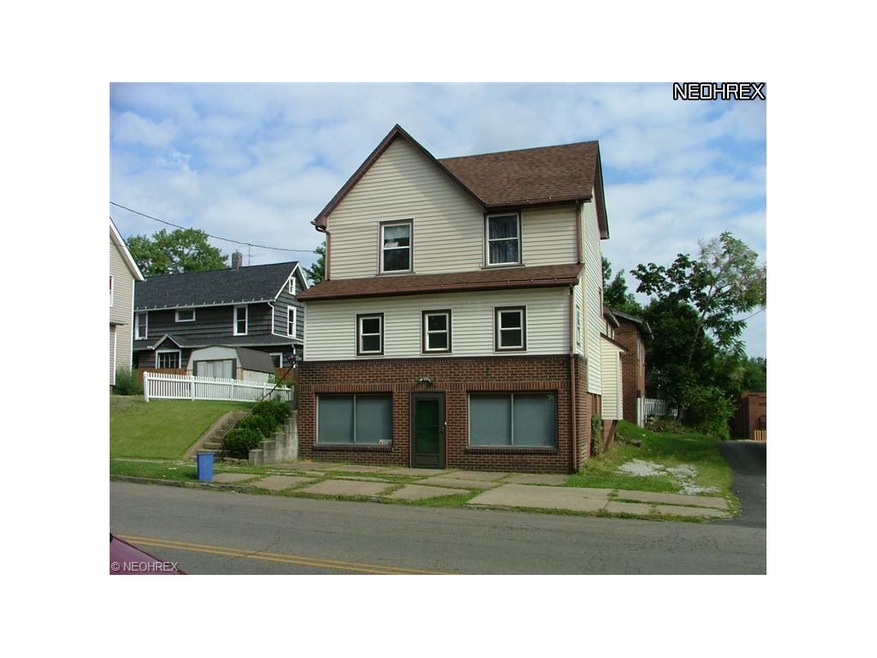 Two story home with basement entry off sidewalk.  