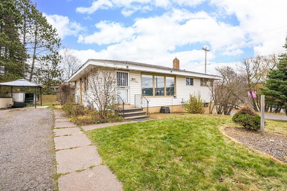View of front of property featuring a front yard and a chimney