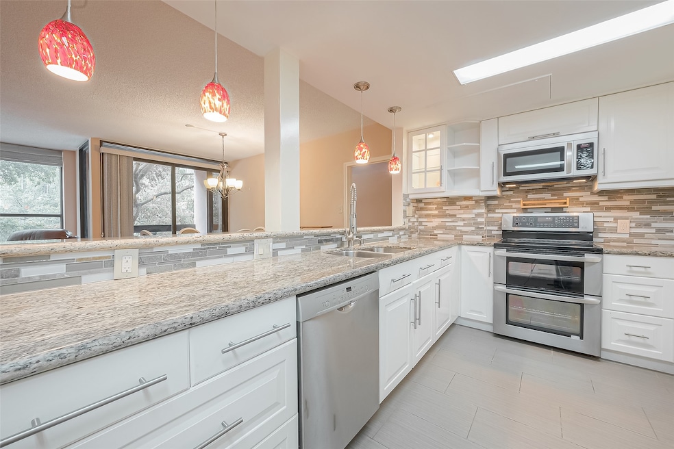 A stylish pendant light hangs over the counter tha