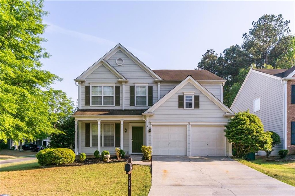 View of front facade featuring concrete driveway, 