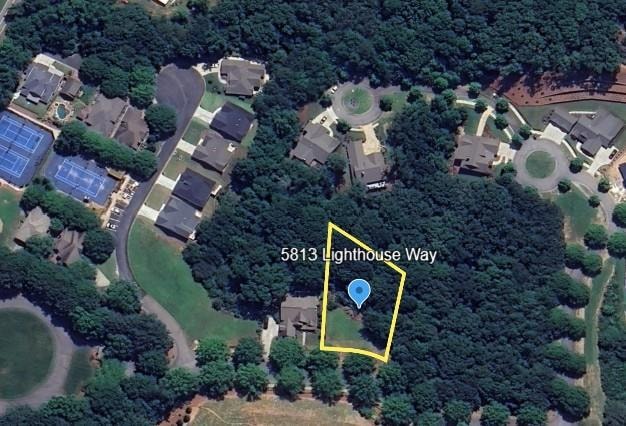 Aerial view of property and surrounding area featuring nearby suburban area and property boundaries highlighted