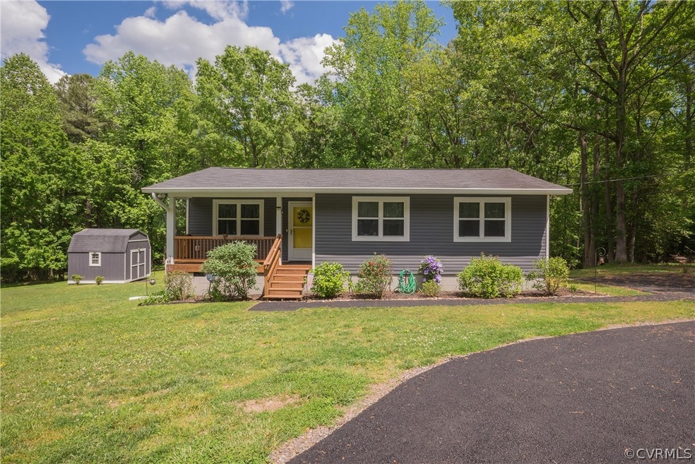 View of front of home with a front lawn, a storage