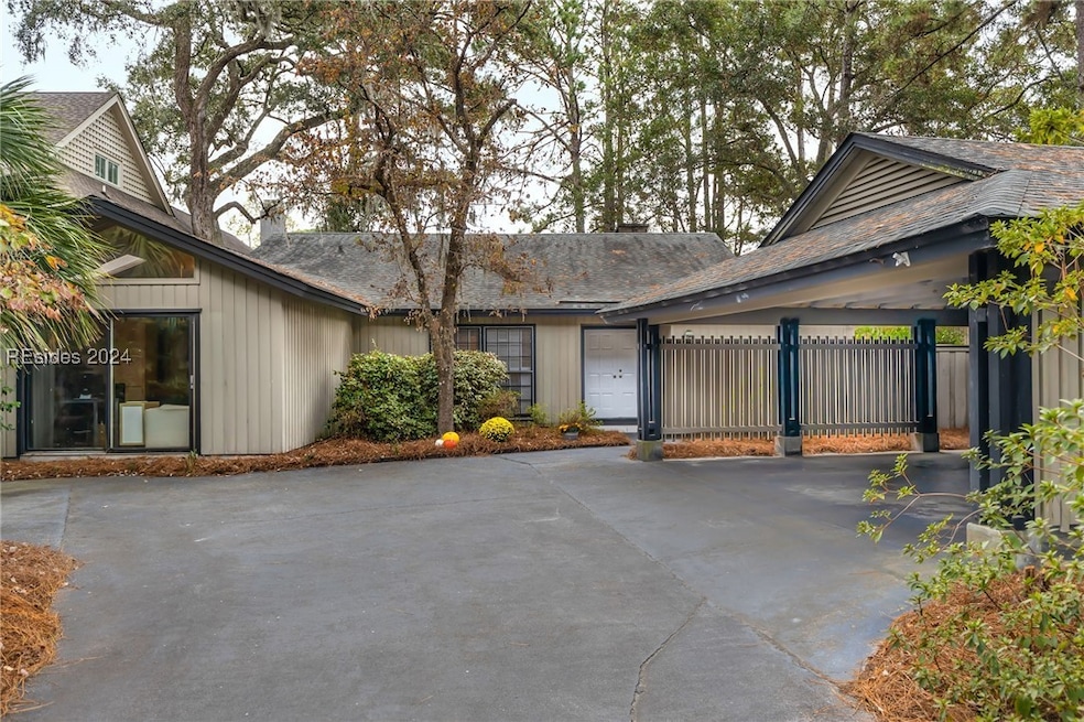 Front elevation with view of the front door and ca