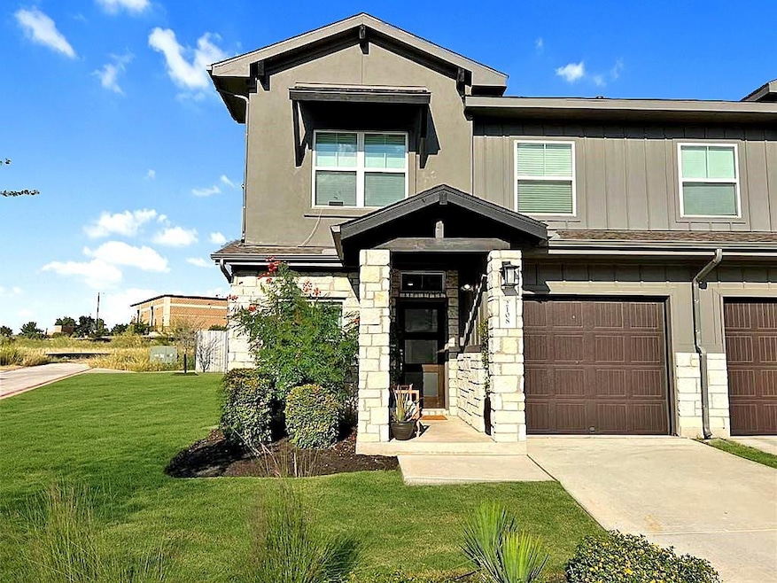 View of front of house with a garage, a front yar