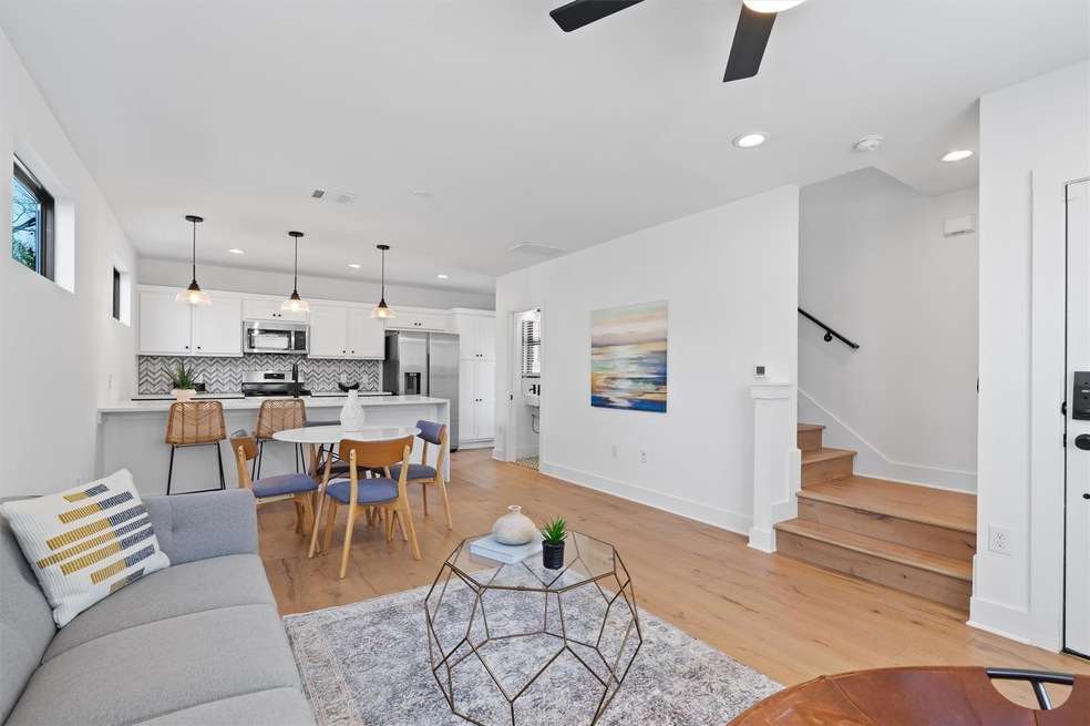 Living area with recessed lighting, stairs, light