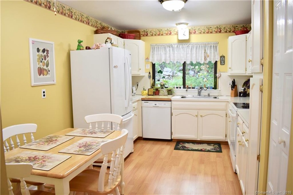 Eat-in kitchen with wood floors and pantry looking