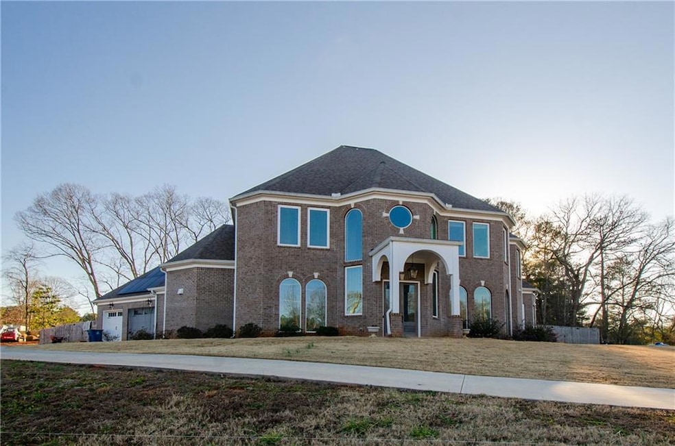 View of front of property with brick siding and driveway