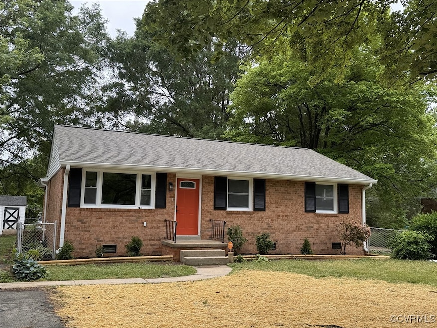 View of front facade with crawl space, brick sidin