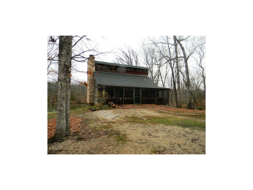 Front View of Cabin with Lake Behind
