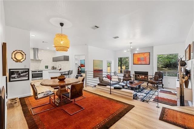 Sunken living room looks out big picture windows to the back yard. Snuggle up next to the fireplace on cold nights, (if you remember what those feel like!).
