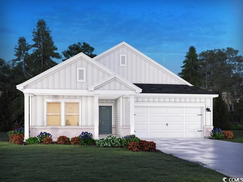 Modern inspired farmhouse with a garage, a front y