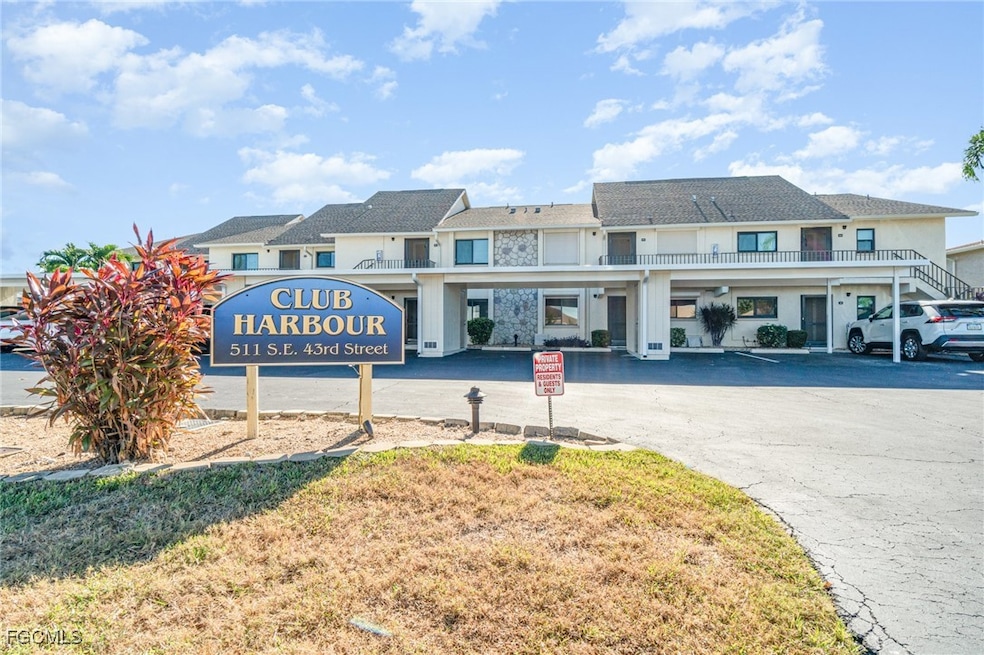 View of building exterior featuring covered parking
