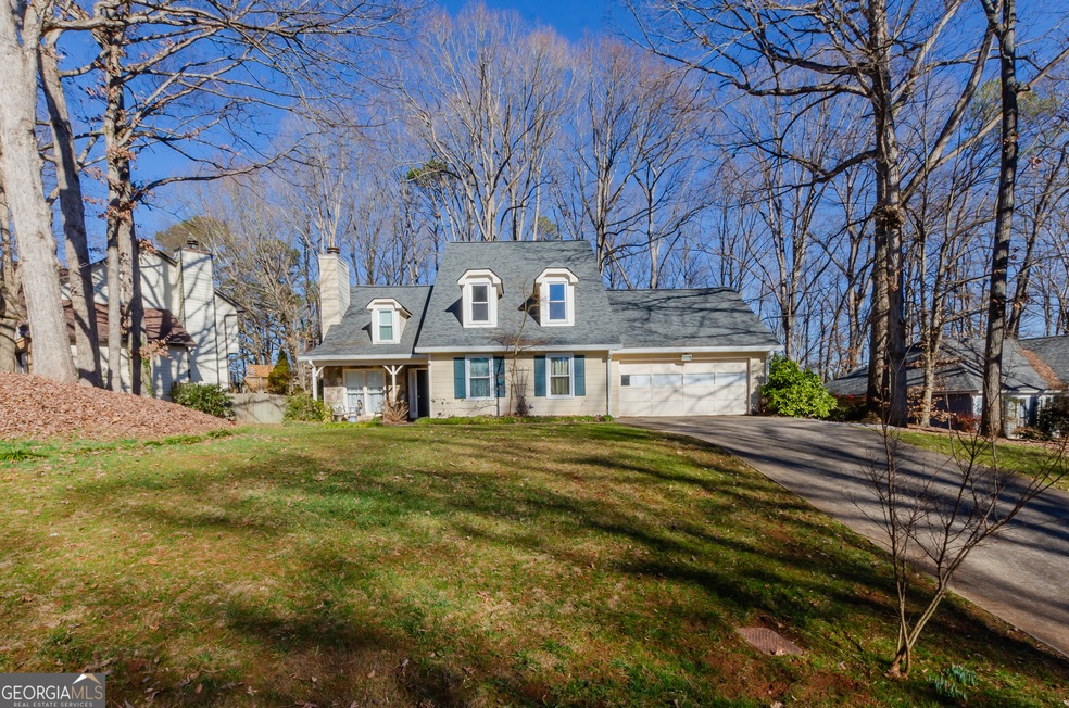 New England style home featuring a 2 car garage, a