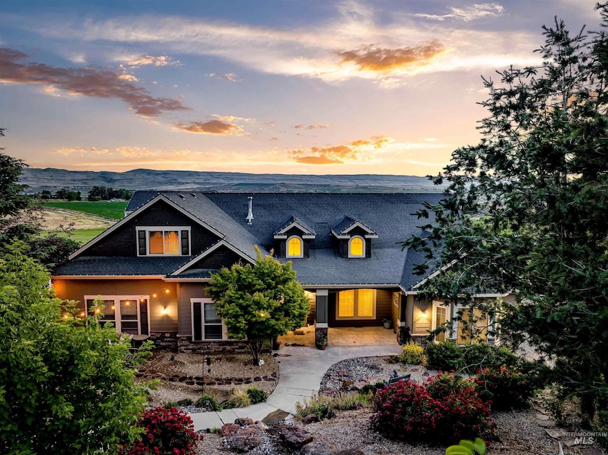 View of front of home with a shingled roof, stone siding, and a mountain view