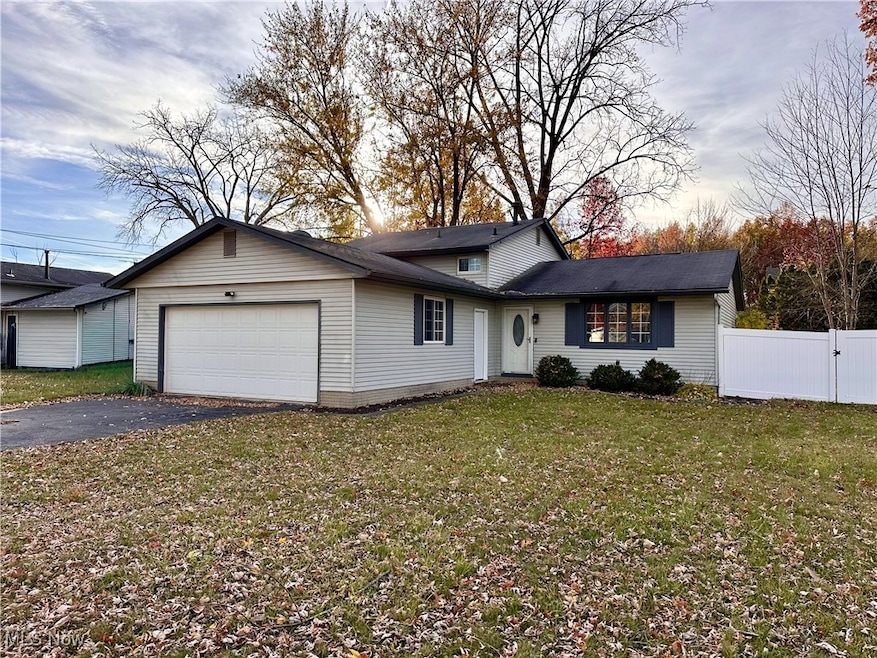 View of front of property featuring an attached garage and driveway