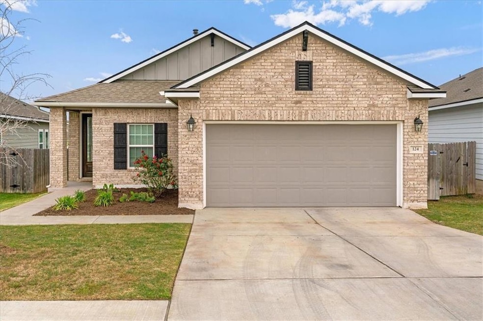 Ranch-style home with concrete driveway, board an