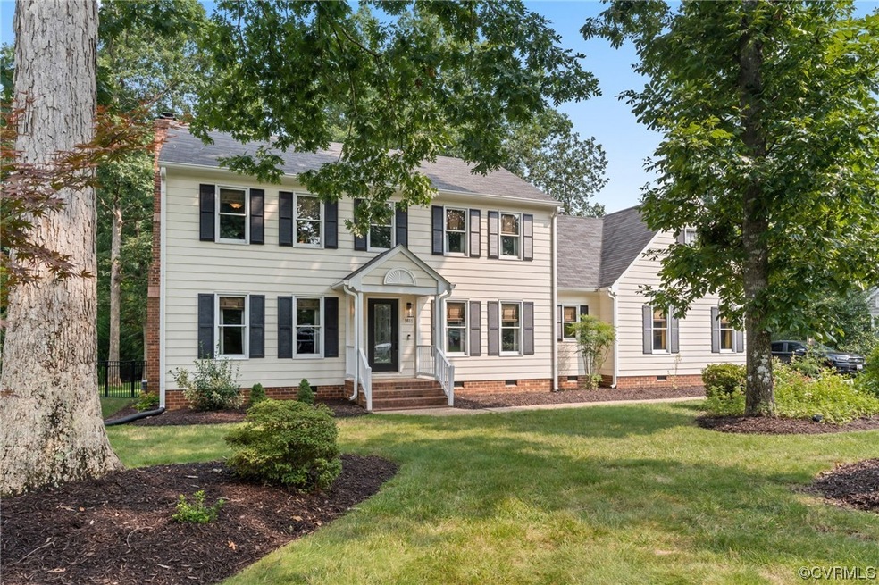 Colonial-style house featuring a front lawn