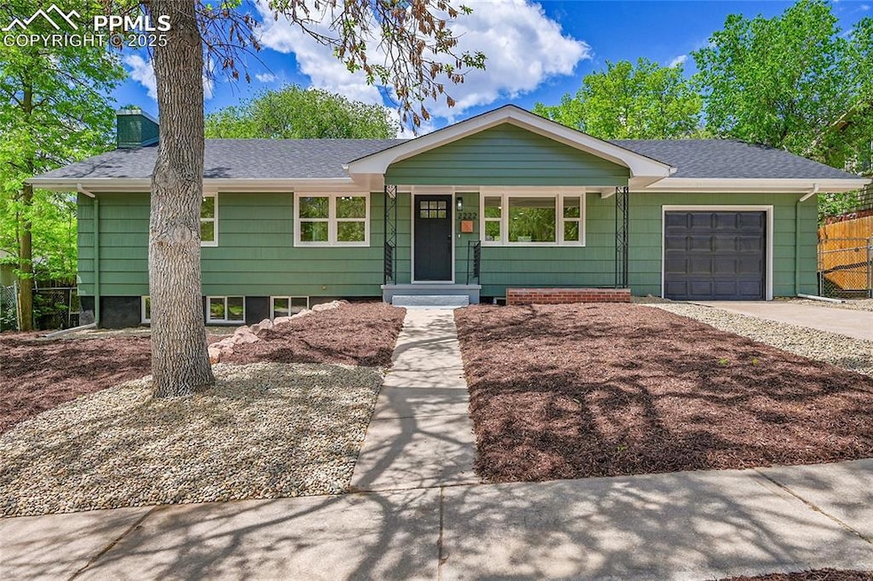 Ranch-style home featuring a garage, roof with shingles, and driveway