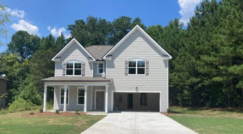 View of front of home with a front lawn and covere