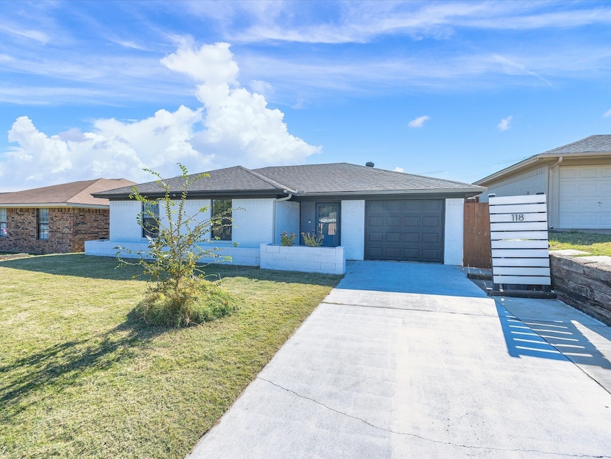 Single story home featuring roof with shingles, concrete driveway, a front yard, and a garage