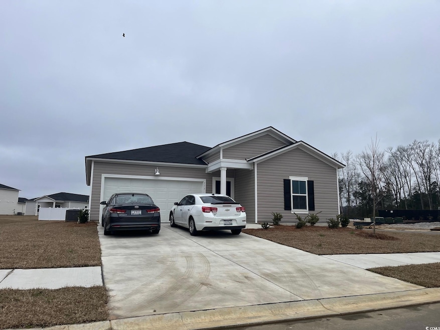 Ranch-style house with driveway and an attached ga