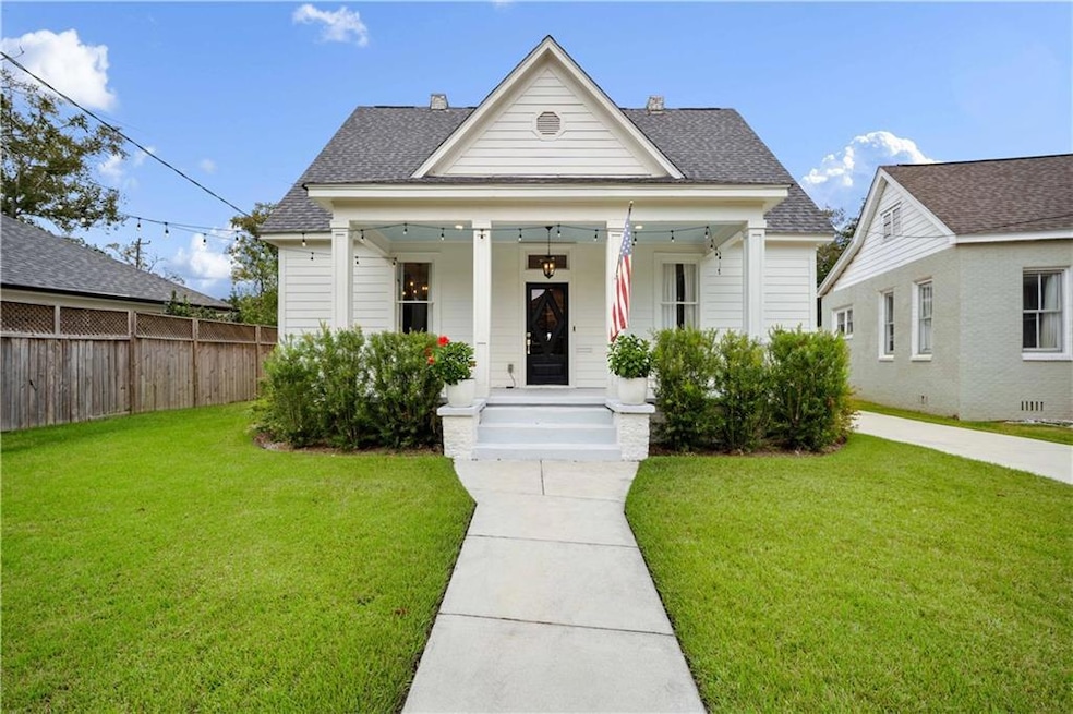 View of front of home featuring roof with shingles and a porch