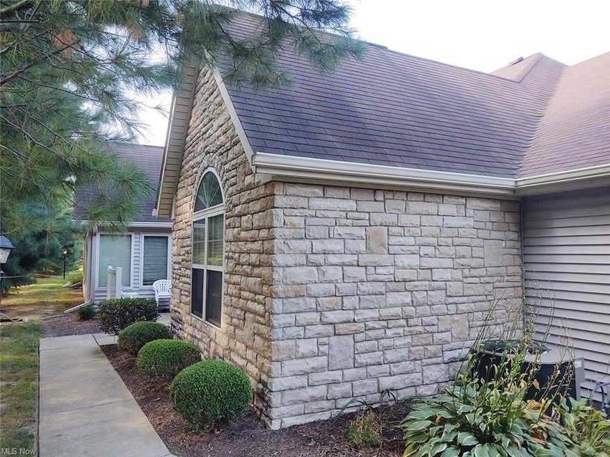 Front of stone and vinyl condo