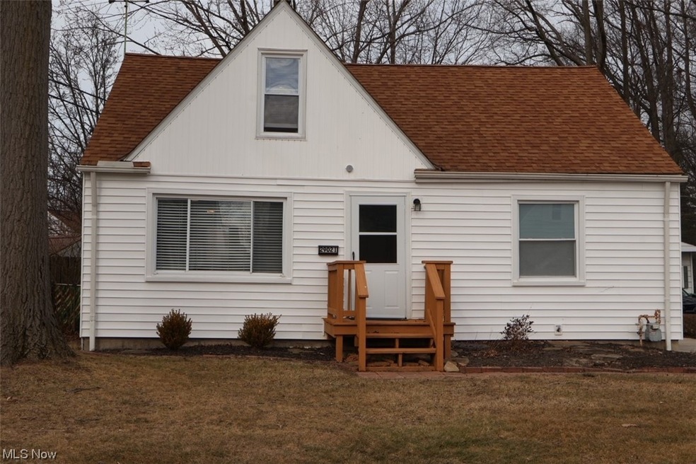 Rear view of house with a yard