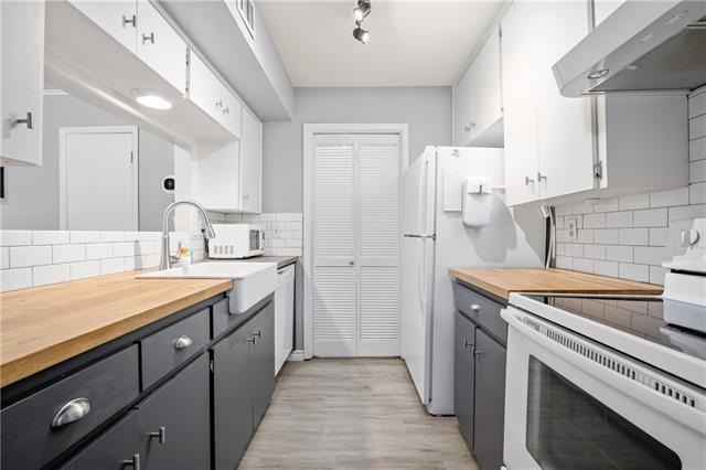beautiful galley kitchen with butcher block counte