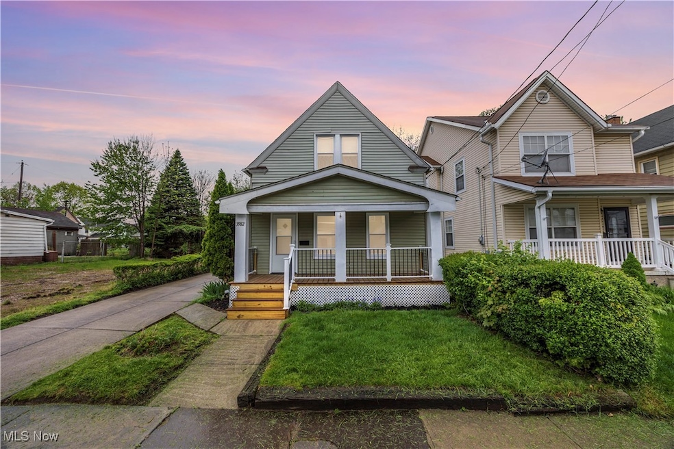 View of front facade with covered porch and a lawn