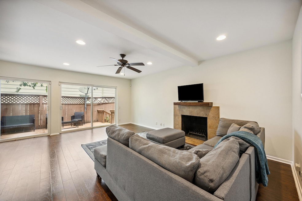 Living room with dark wood-style flooring, ceilin