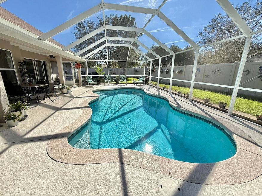 View of pool with a patio, a sunroom, glass enclosure, and a fenced backyard