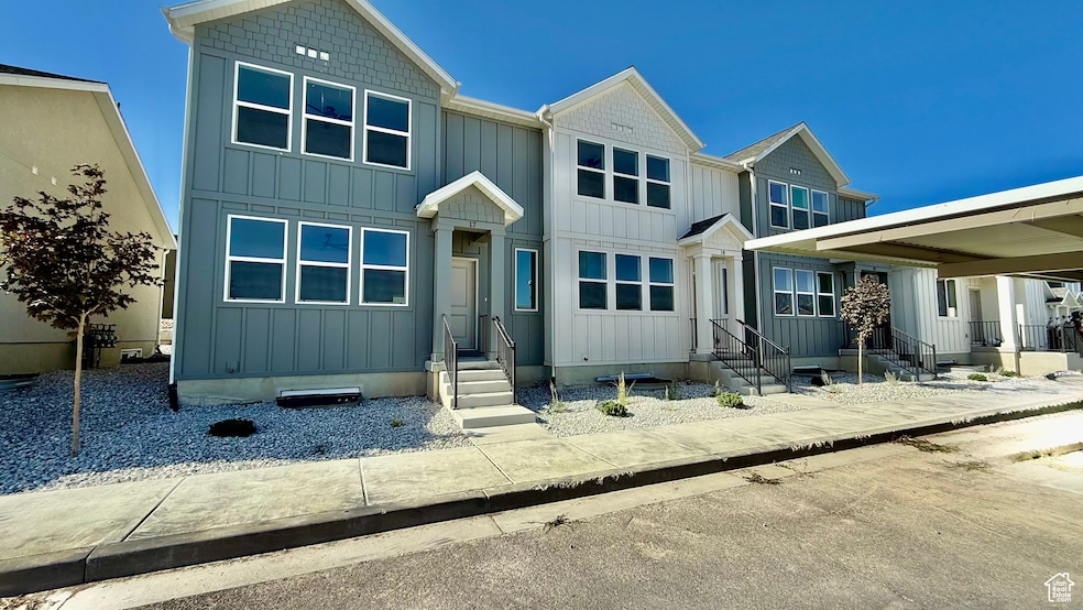 View of front of home with board and batten siding and entry steps