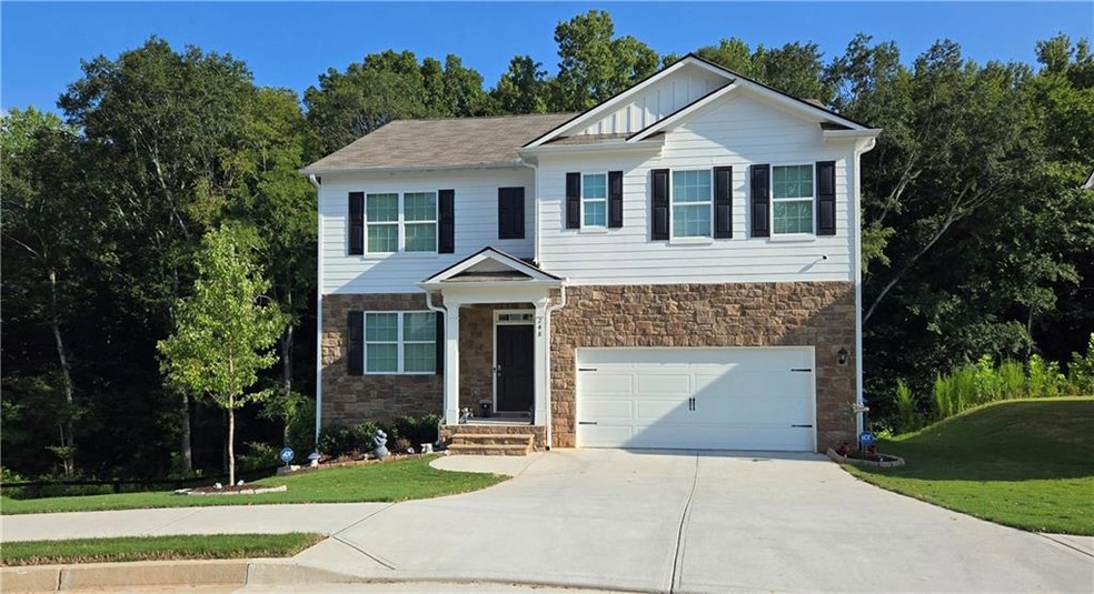 View of front of house with a front yard and a gar