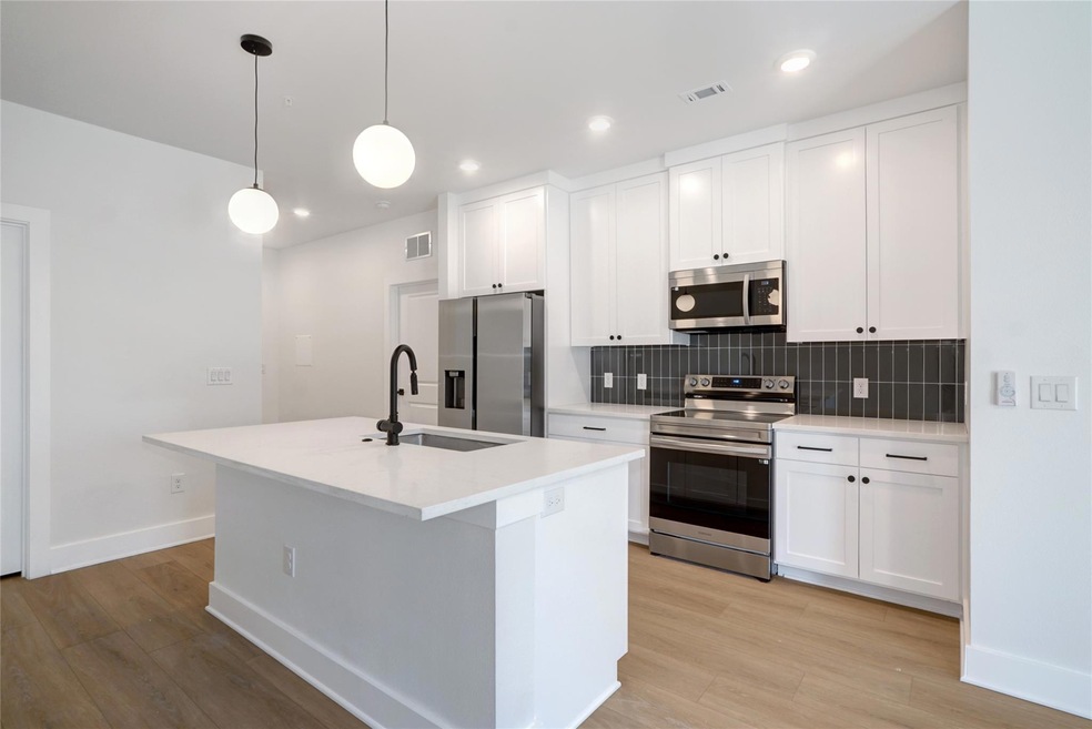 Kitchen featuring stainless steel appliances, a s
