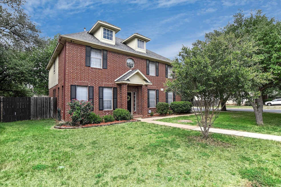 Georgian-style home with brick siding