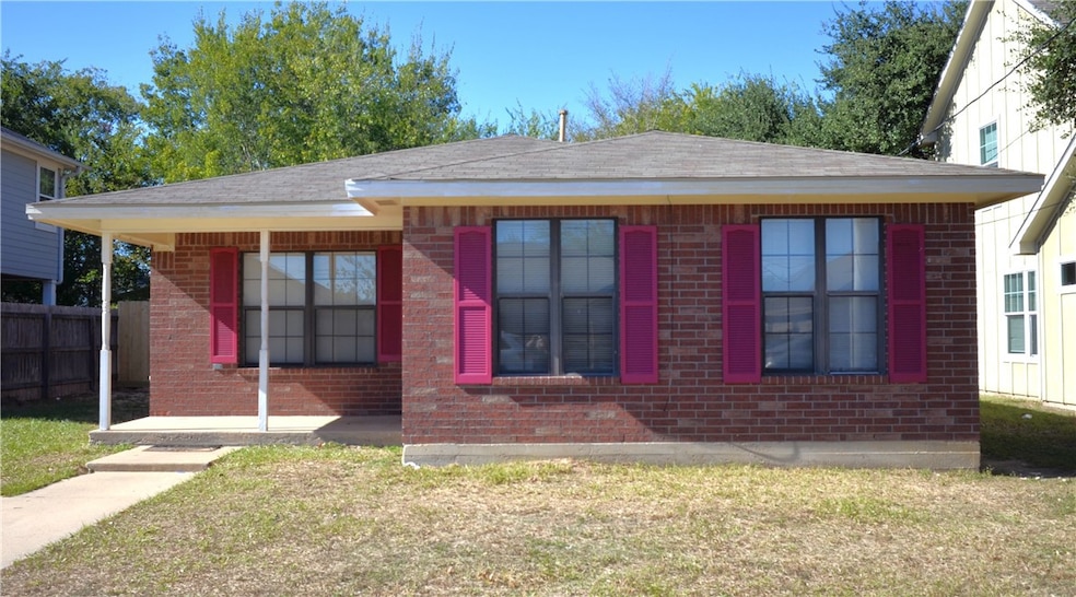 View of front of property featuring covered porch and brick siding