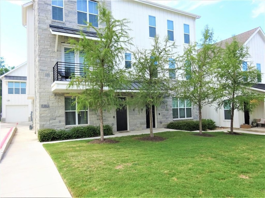View of front of house featuring stone siding, a 
