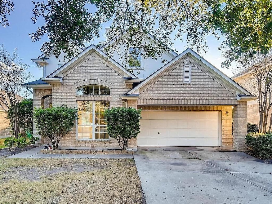 View of front of property featuring a garage, con