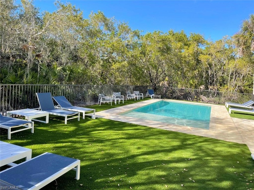 View of swimming pool featuring a patio and view of scattered trees