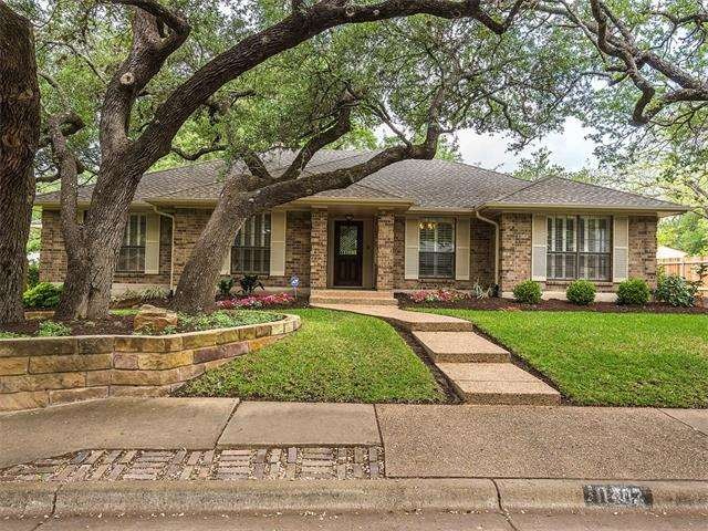Rare one-story custom home in Spicewood is shaded 