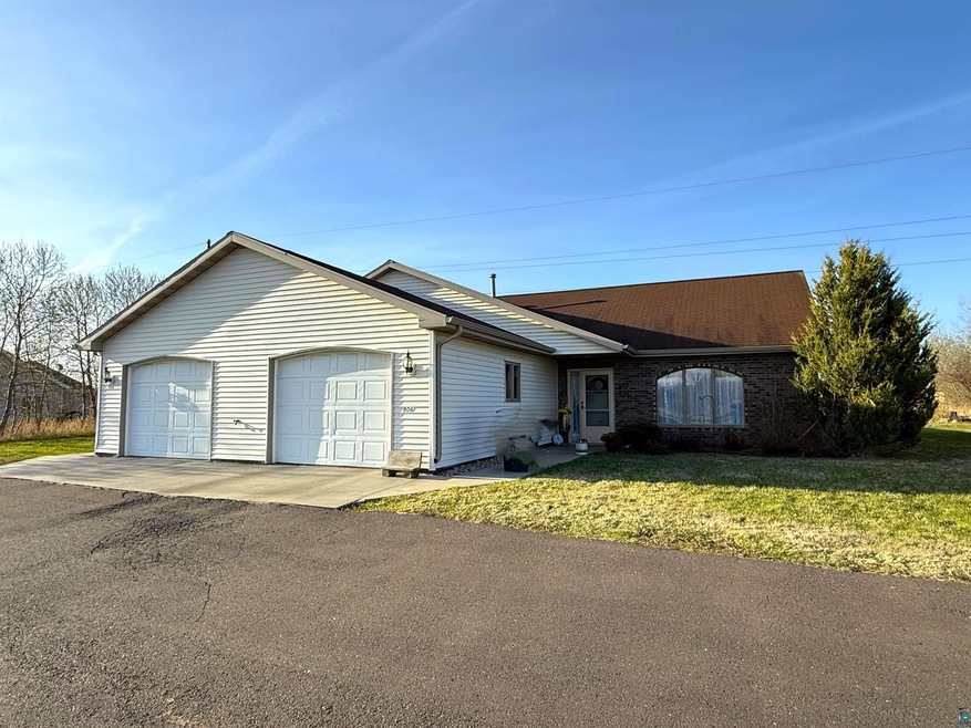 Ranch-style house with a front lawn and a garage