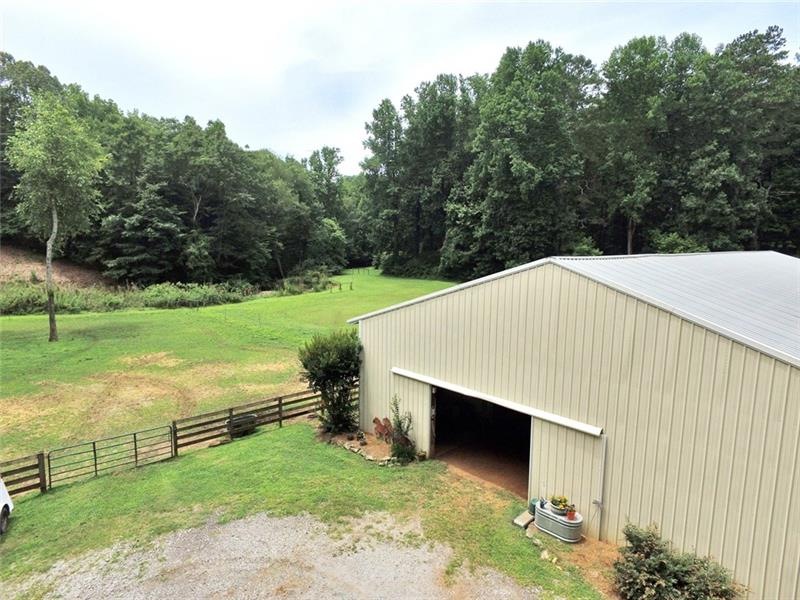 Charming horse farm is surrounded by neighboring f