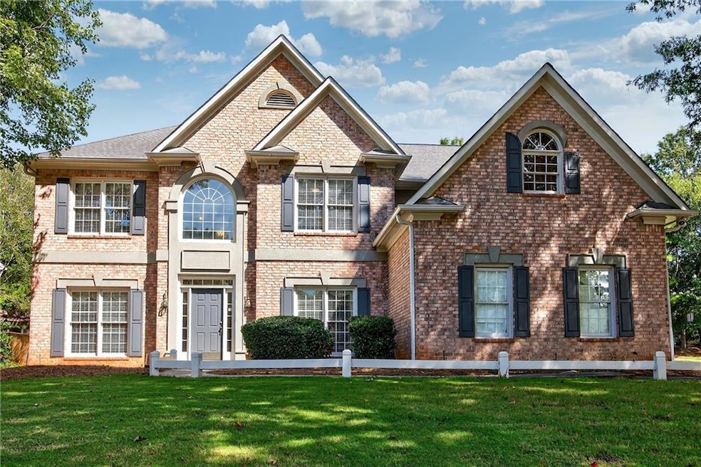 View of front of house with a front lawn and brick siding