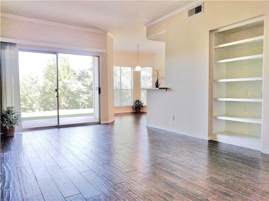 Unfurnished living room featuring crown molding, 