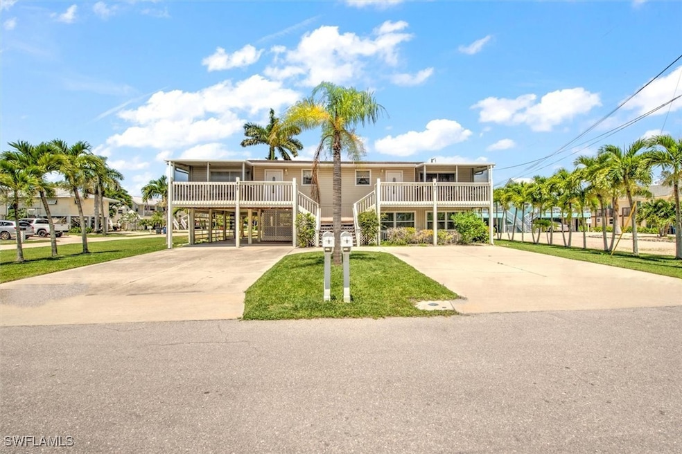 View of front of home with a front lawn, a carport