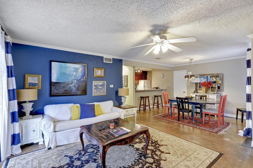 Living area with ceiling fan, crown molding, and 