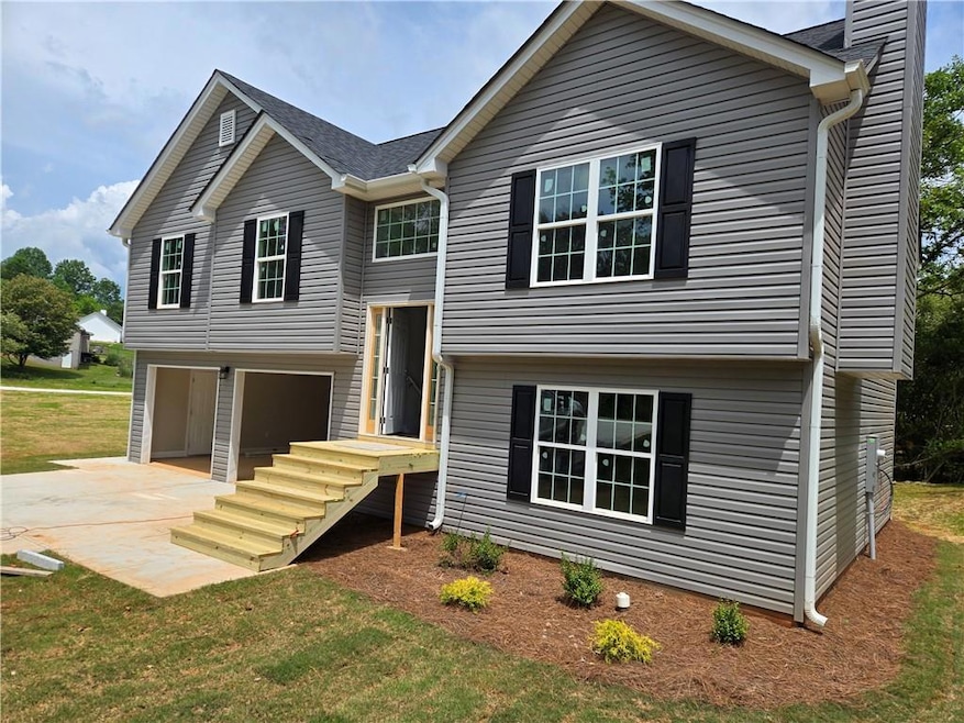 Raised ranch with an attached garage, driveway, a 